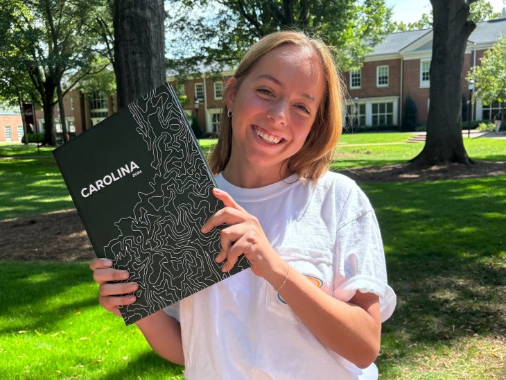 Coral Clark hold the yearbook.