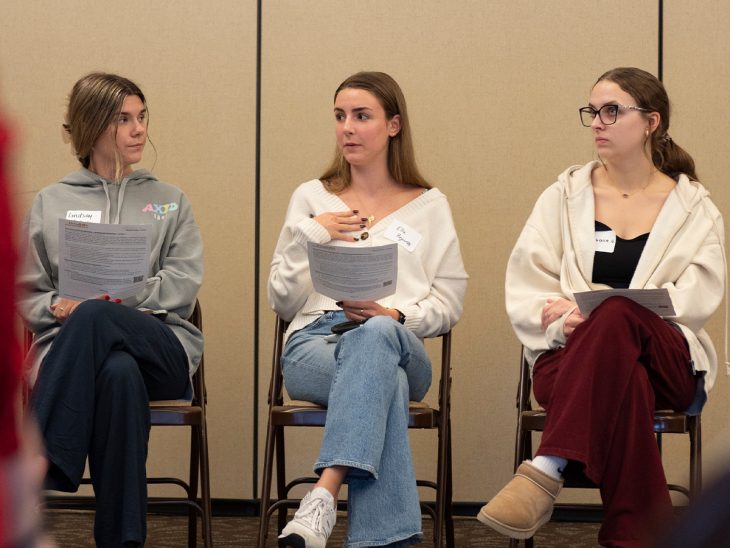 Three students sit in a row