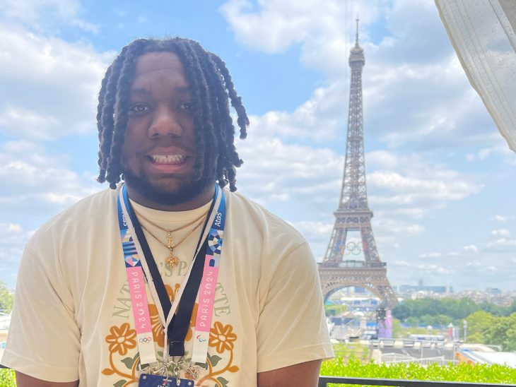 Emmanuel Morgan stands in front of the Eiffel Tower