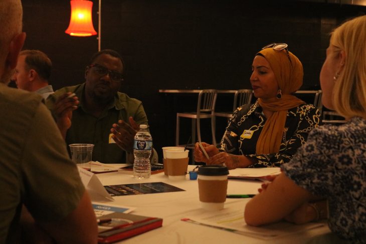 People sit at a table and talk