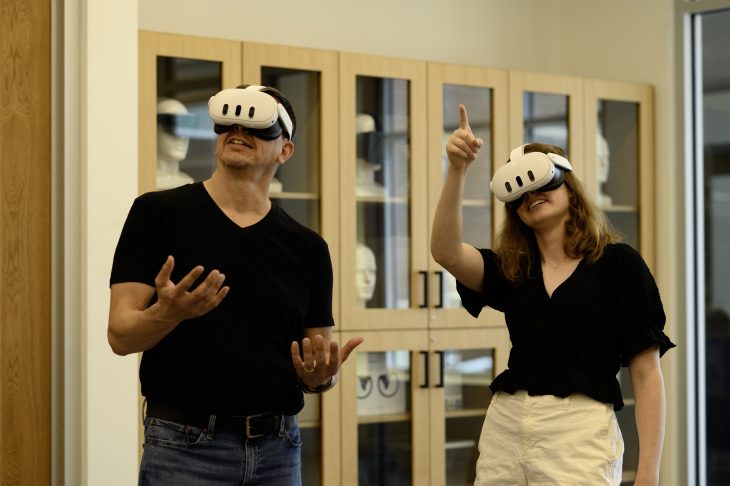 Two people use virtual reality headsets