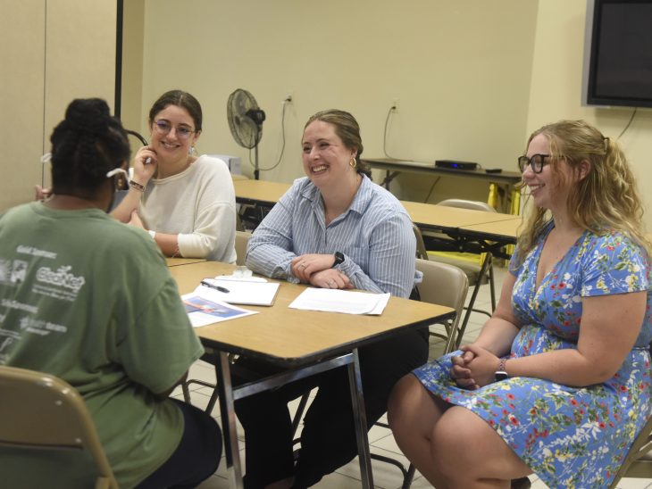 Elon Law students (from left) Talia Traversa L'26, Cuyler Field L'24, and Brooke McCormick L'24 assist a client on September 26, 2024, at the Roy B. Culler, Jr. Senior Center in High Point, North Carolina, where they worked under the supervision of Visiting Professor of Law Susan Ross.