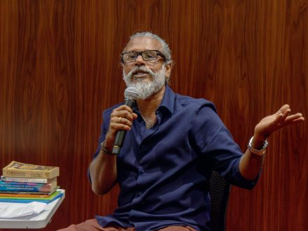 Shehan Karunatilaka speaks into a microphone