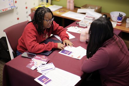 Two students sit at table