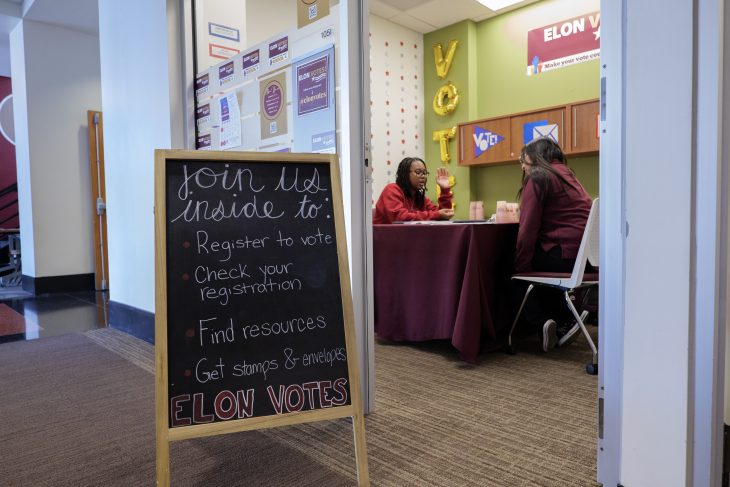 Two students sit in the Moseley Center Elon Votes office