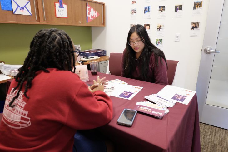 Two students sit at table