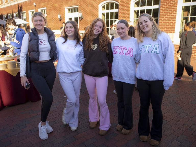 A group poses during College Coffee