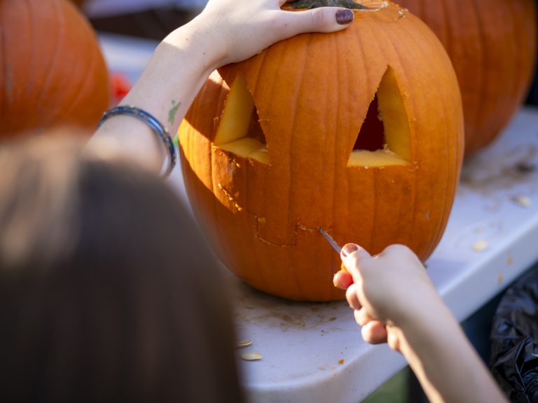 Person carves pumpkin