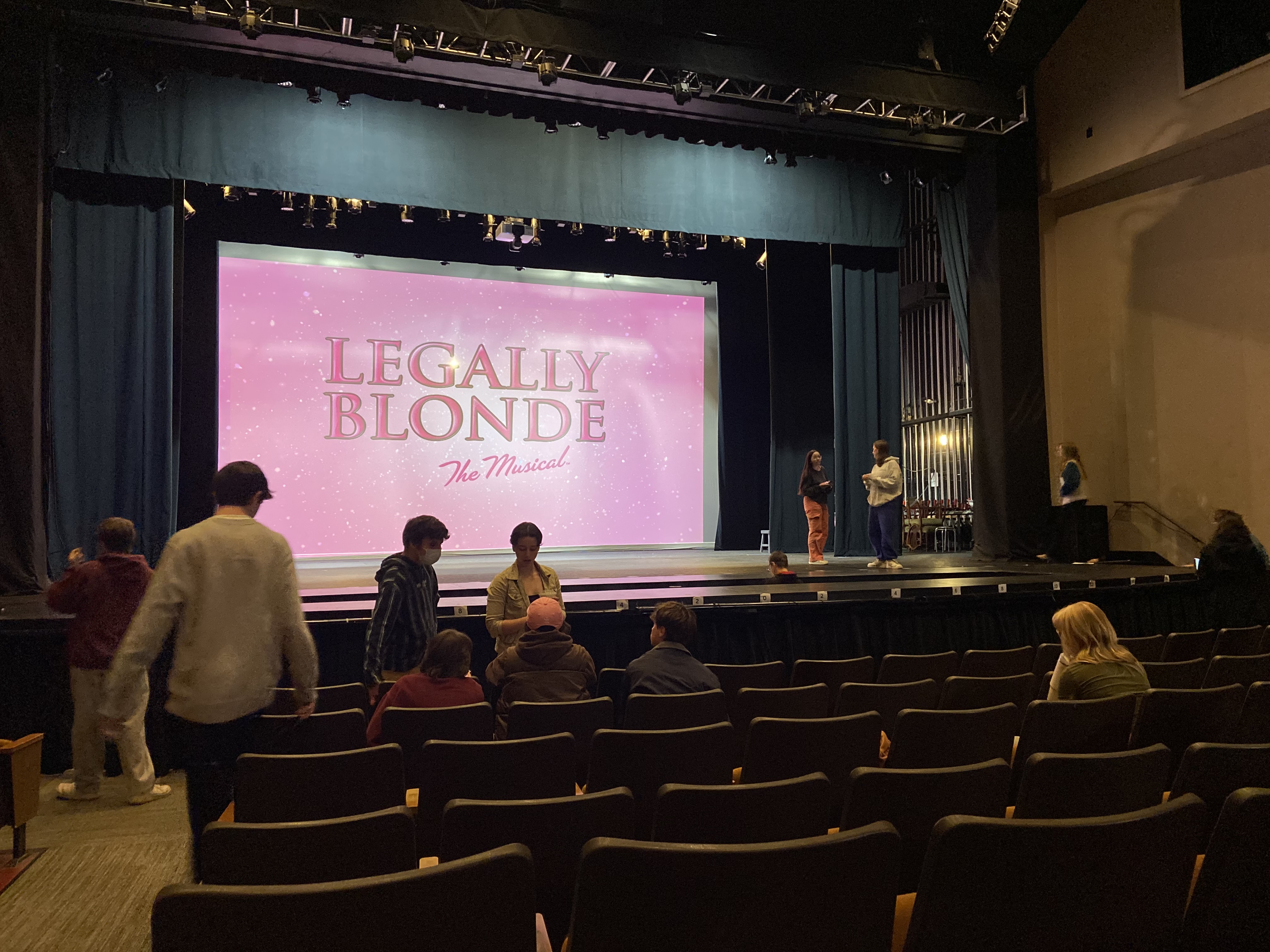 A stage with the Legally Blonde logo