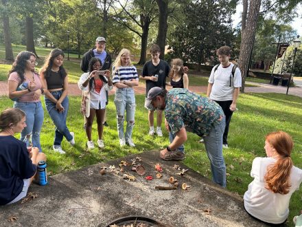 Students stand in circle