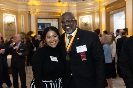 Two guests pose for a photo at the event.