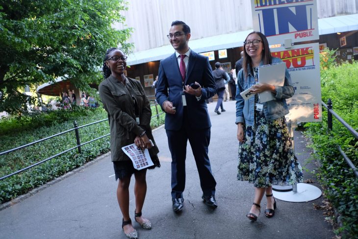 Three people stand together at the Delacorte Theater