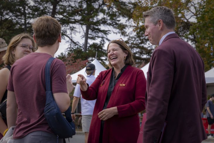 Connie Book talks with three people