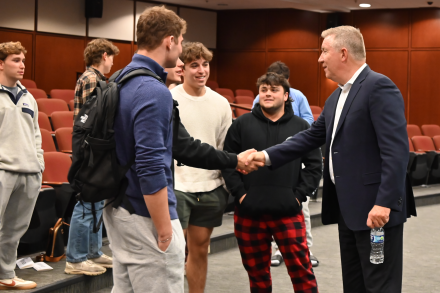 Jim Rooney talking one-on-one with students after event