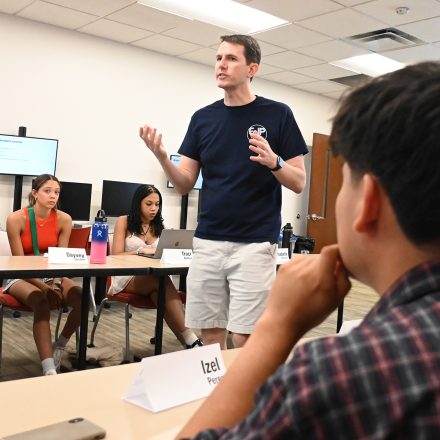 Kelly Furnas stands in an Elon School of Communications classroom.