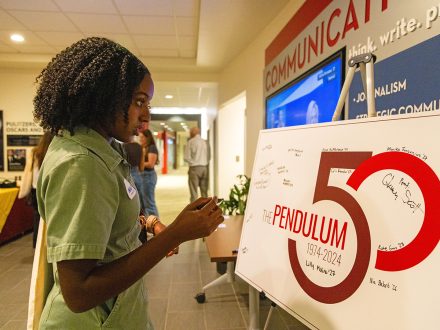 Naomi Washington '24 stands in McEwen Communications Building.