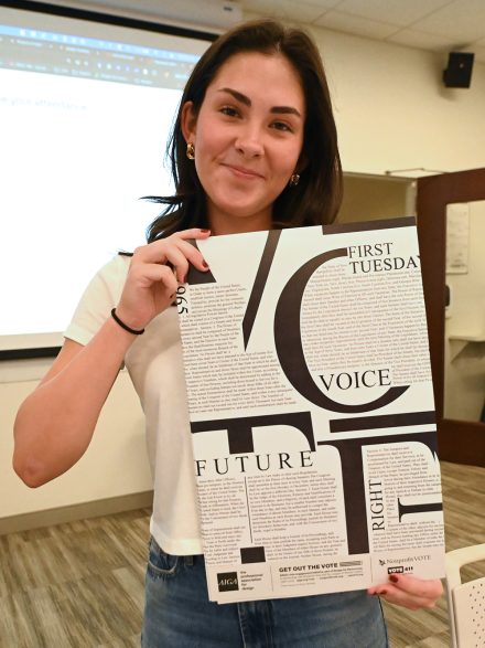 Reese McNally '25 of Elon University smiles with a poster.