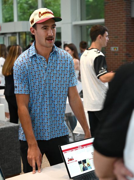 Ryan Harper ’25, an Elon student, talks to another sport management major.