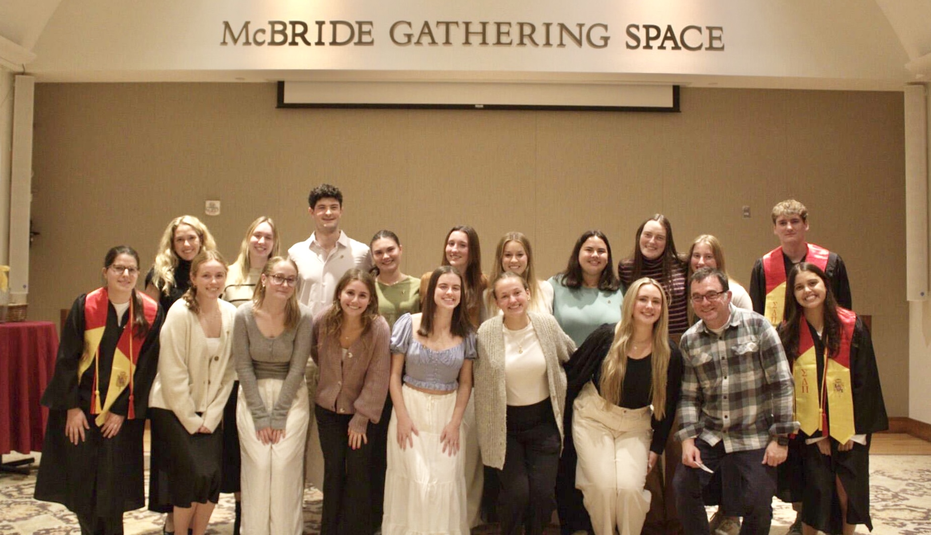 Group poses for photo in McBride Gathering Space