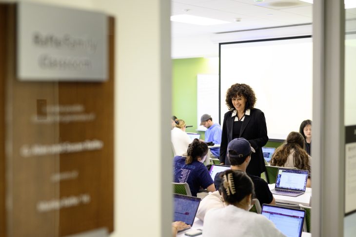 Door frame. Through door frame, Karen Lindsey is smiling at students