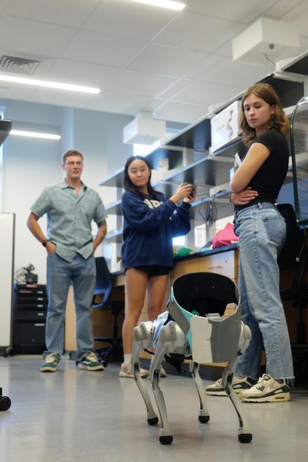 Students test a quadruped in an engineering lab at Elon University.