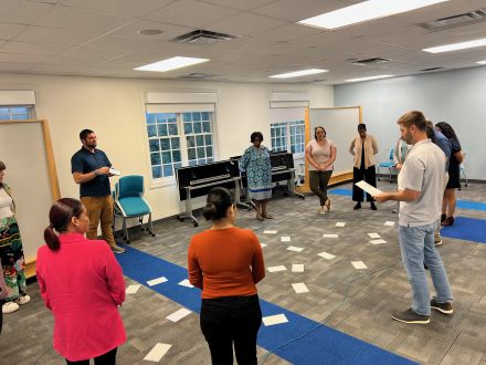 Several people stand in a circle