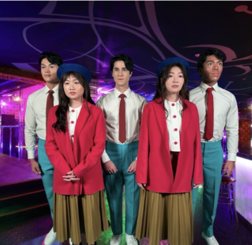 Five people pose. Two people are wearing red cardigans in front. Three people in white shirts are behind