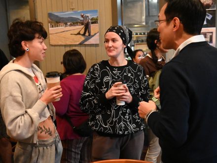 Elon professor Young Do Kim talks to two students.