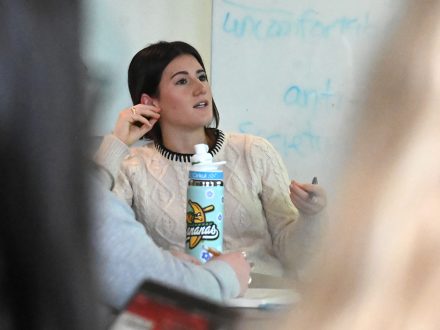 Charlotte McCormick, an Elon student, looks on during a class discussion.