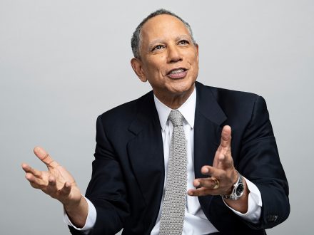 Dean Baquet extends his hands as he gestures.