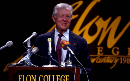 Jimmy Carter stands behind podium