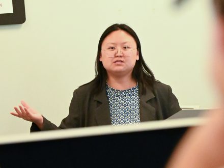 With students listening attentively, Assistant Professor Chris Chen stands at the front of a classroom