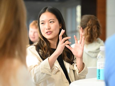 Elon student Julia Chan ’28 speaks at a table.