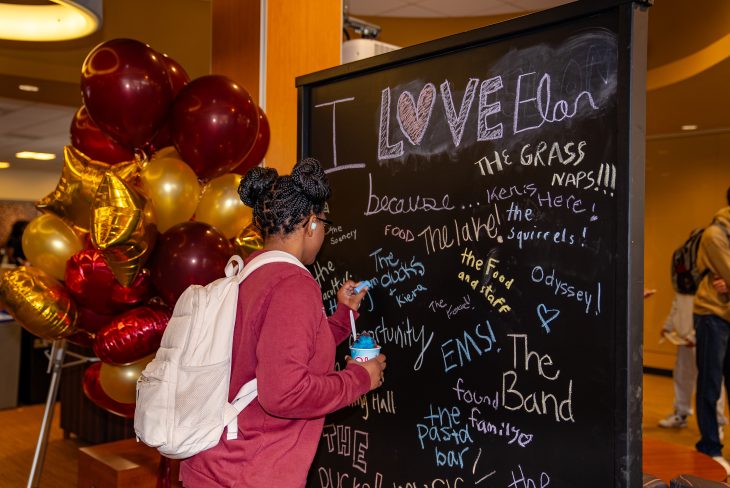 Student writing on a chalkboard