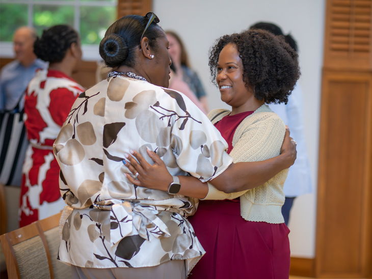 Carla Fullwood, director of inclusive excellence education and development at Elon University embracing someone.