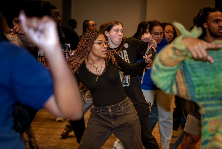 A group of people are in motion dancing