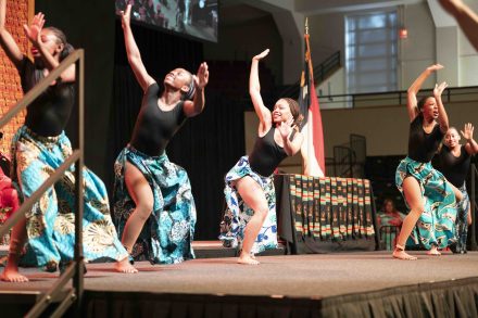 Dancers in ethnic garb perform on stage.
