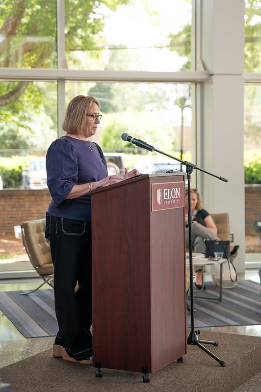 Caroline Ketcham, co-chair, speaks from the podium about the impact of philanthropy.