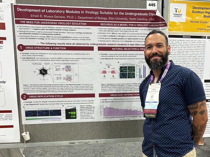 Man stands next to poster presentation