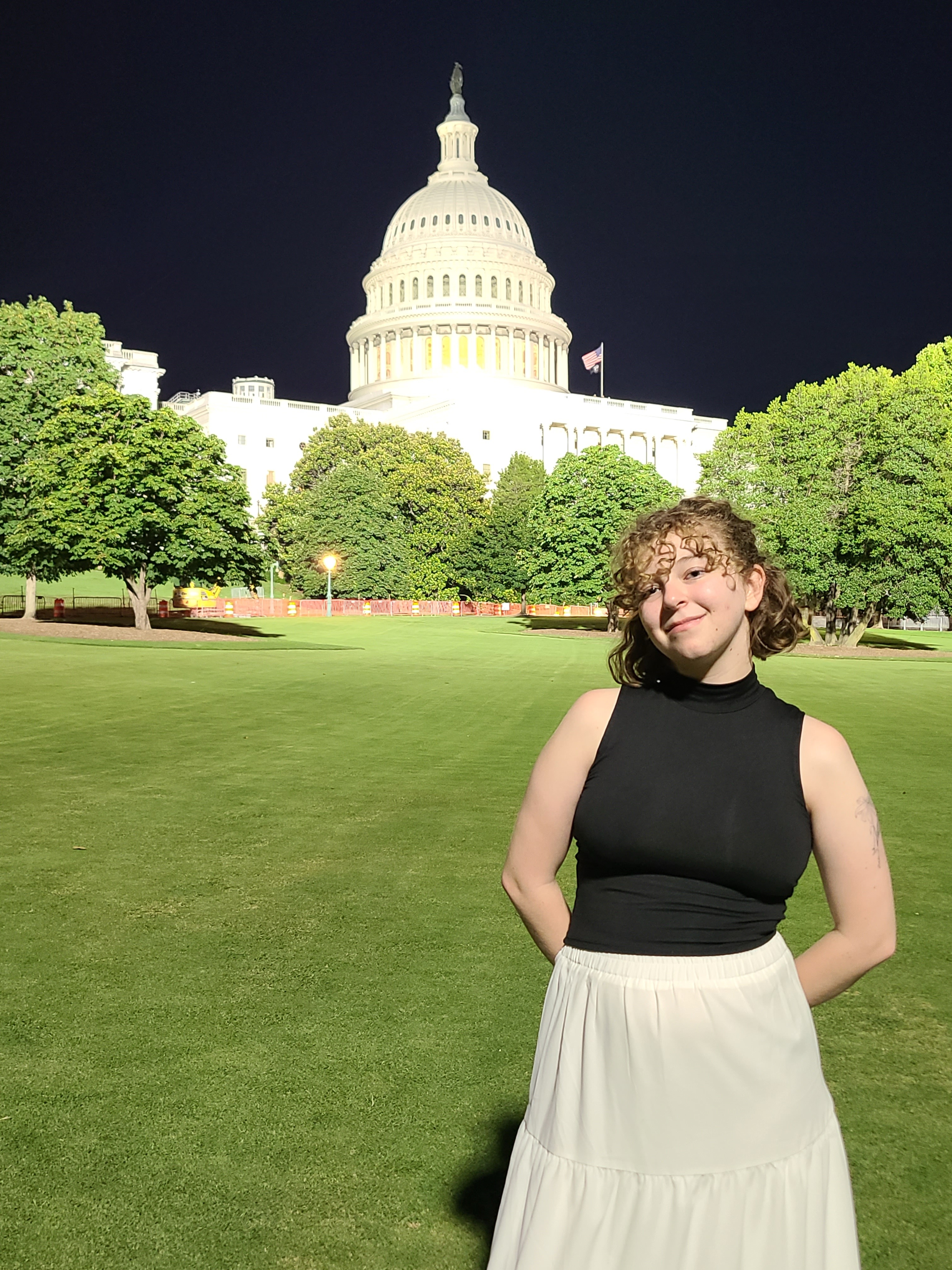 A young woman poses in front of the U.S. Capitol
