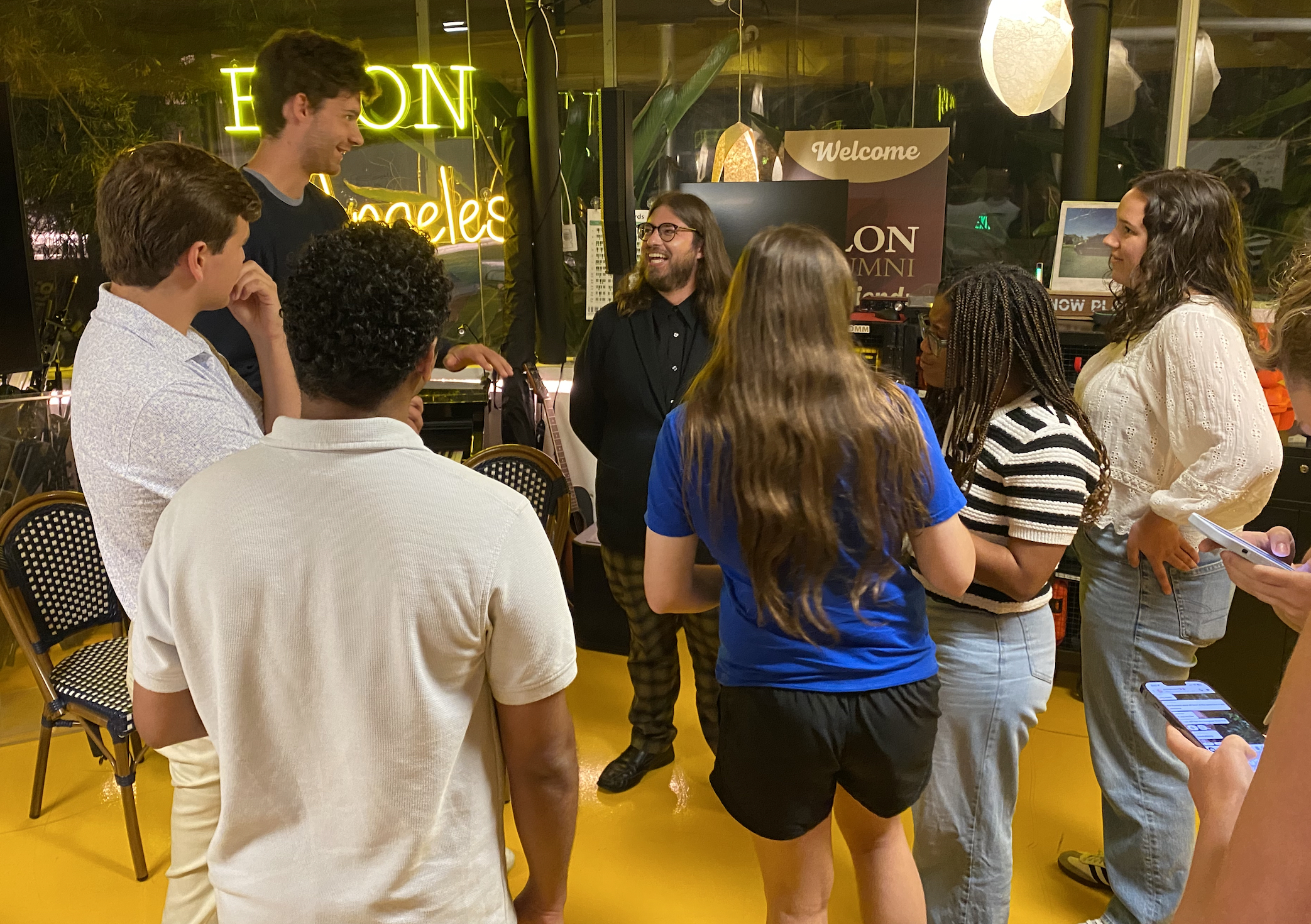 Students gather around and chat with a speaker during an event at the Elon in Los Angeles center.