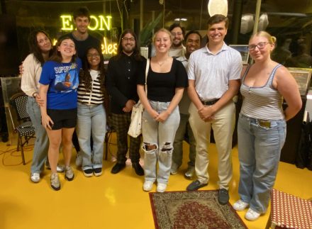 A group of students smiles together for a group photo inside the Elon in Los Angeles center.