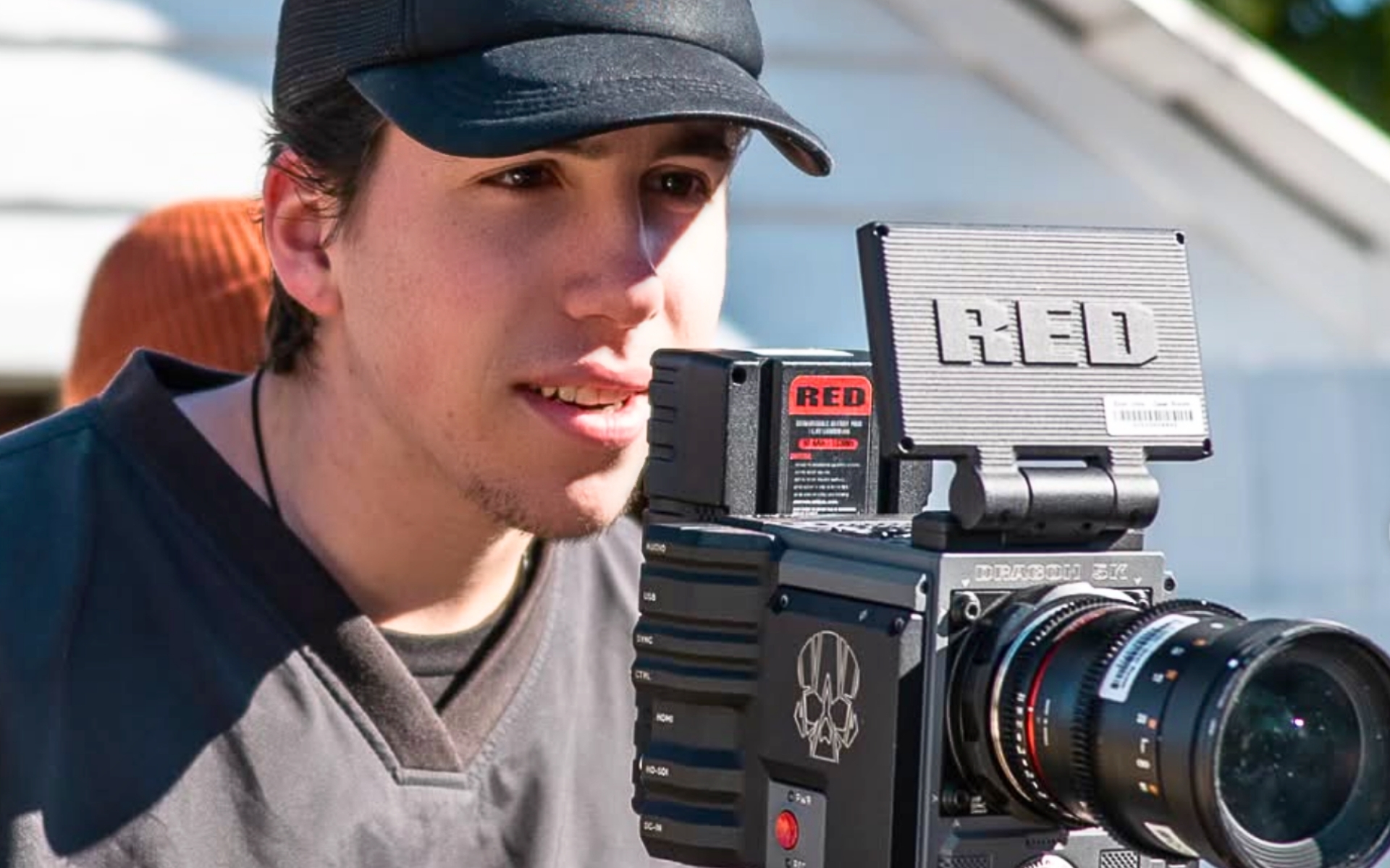 Liam Dupas '26 looks into the live view of a film camera on set