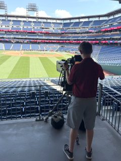 Scott Katz ’26 works a camera inside Citizens Bank Park.