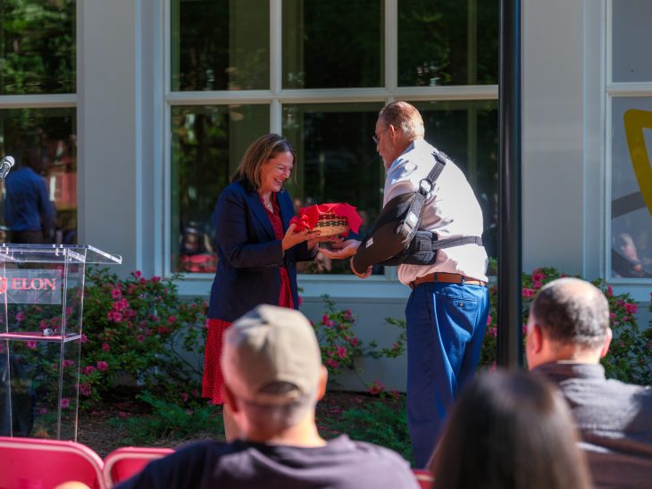 Elon President Connie Ledoux Book and OBSN Tribal Chairperson Tony Hayes exchange gifts during a historical marker dedication ceremony on Sept. 9, 2025 Under the Oaks.