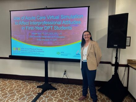 Megan Kim standing in front of her presentation slide.