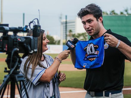 Javik Blake '23 stands with Biloxi Shuckers towel.