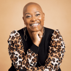 Photo of a woman smiling and leaning on one hand