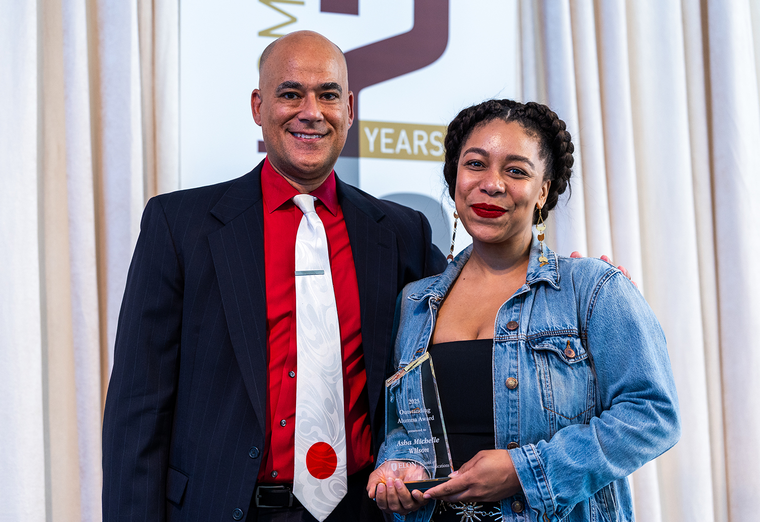 Dean Kenn Gaither stands with Asha Michelle Wilson ’13 