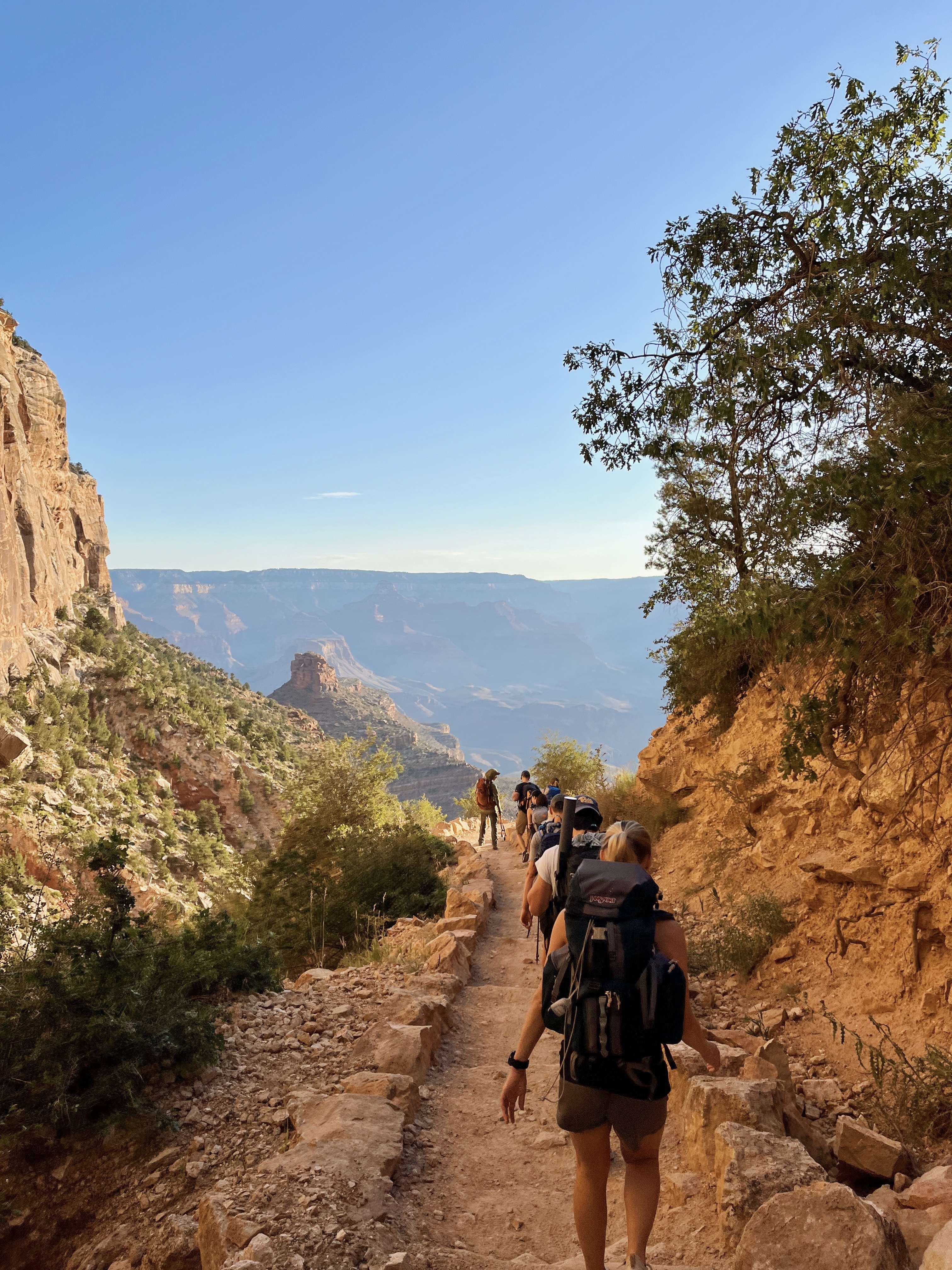 A group of people hiking through the Grand Canyon